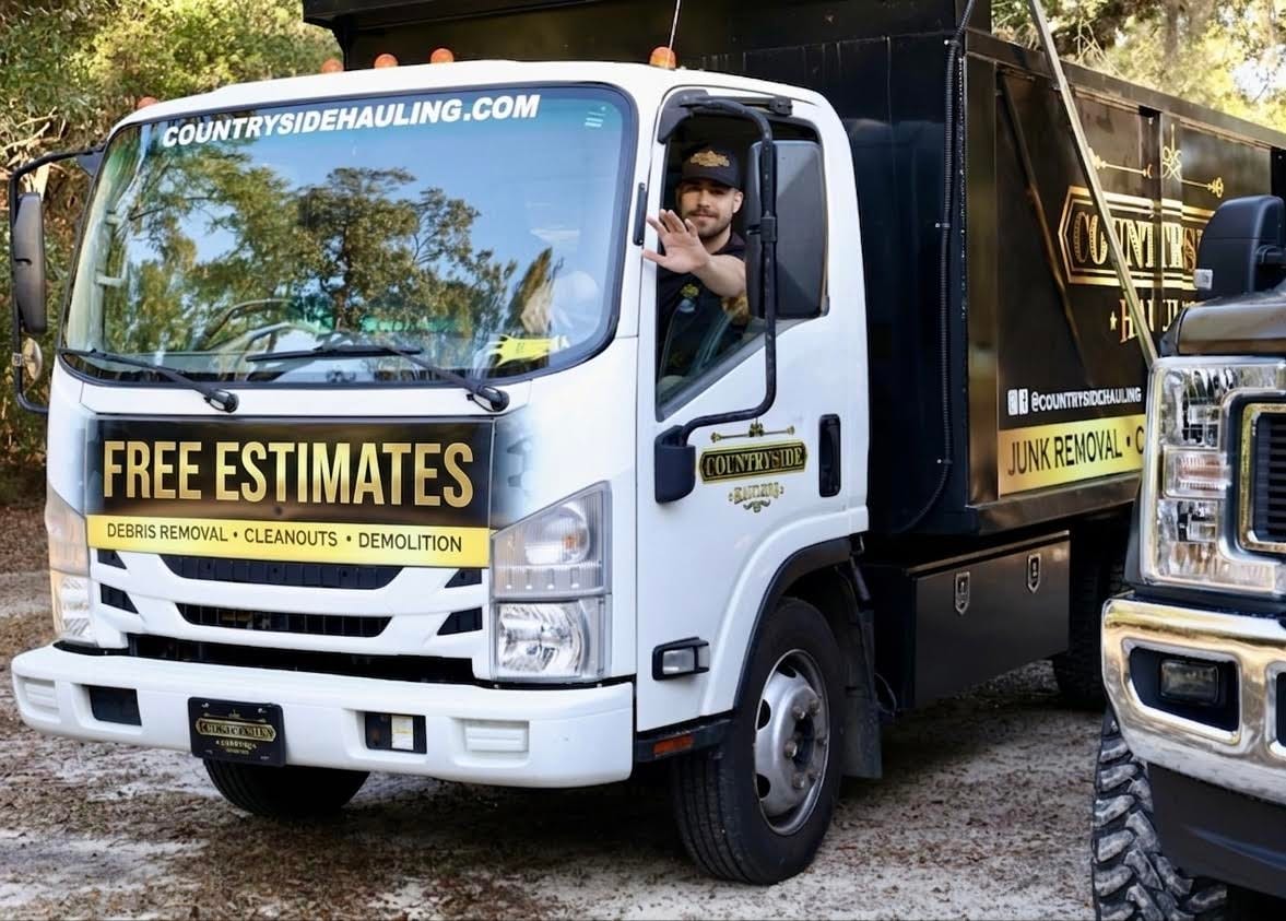 Countryside Hauling Isuzu NPR dump truck arriving in a Jacksonville driveway ready for junk removal